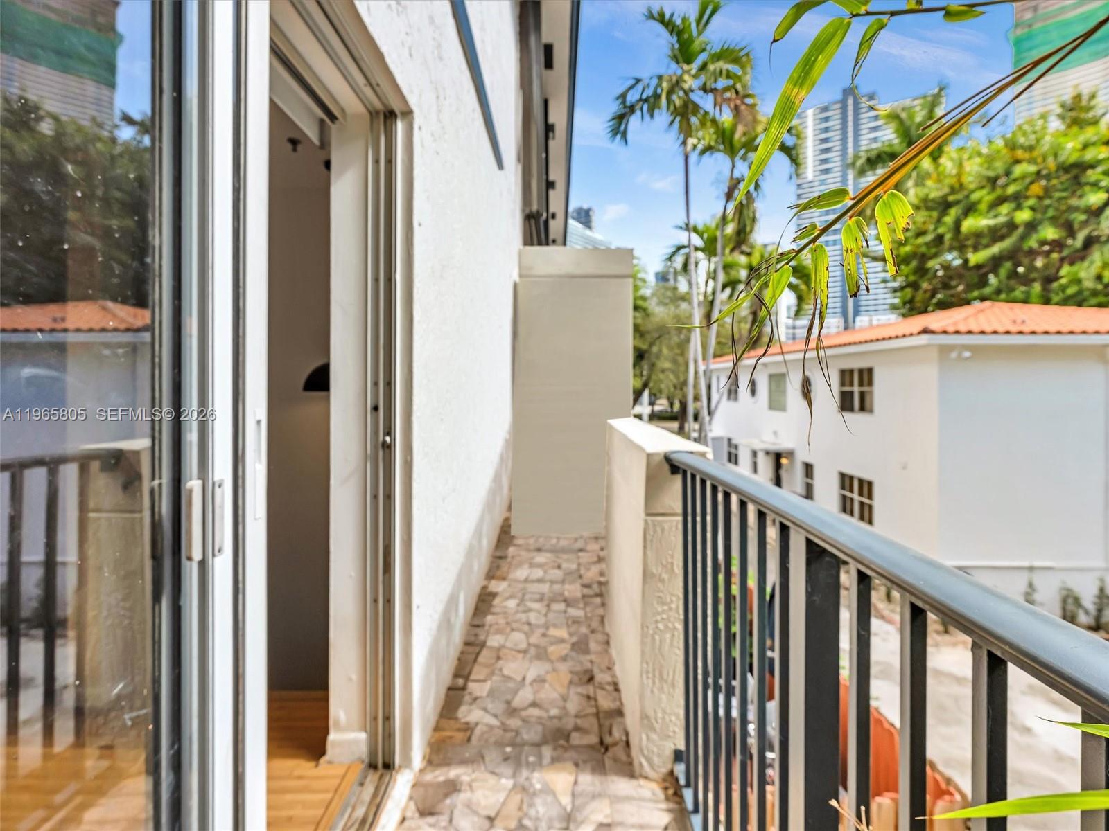 240 Southwest 15th Road, Unit 112 Miami, FL 33129 - Photo 9 of 47 a view of balcony with wooden floor and fence