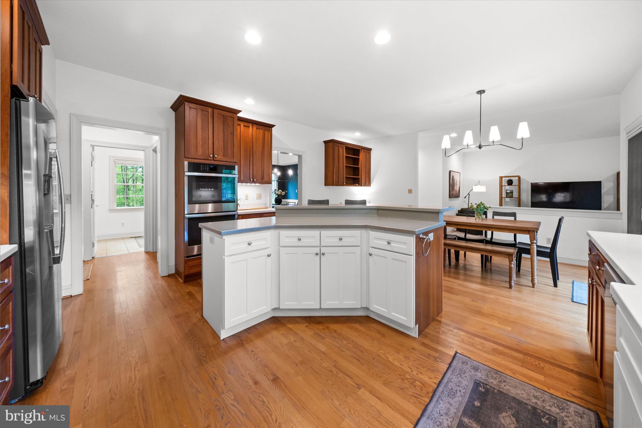 1618 Snuff Mill Road Hockessin, DE 19707 - Photo 15 of 48 a kitchen with granite countertop a stove a sink dishwasher and a refrigerator with wooden floor