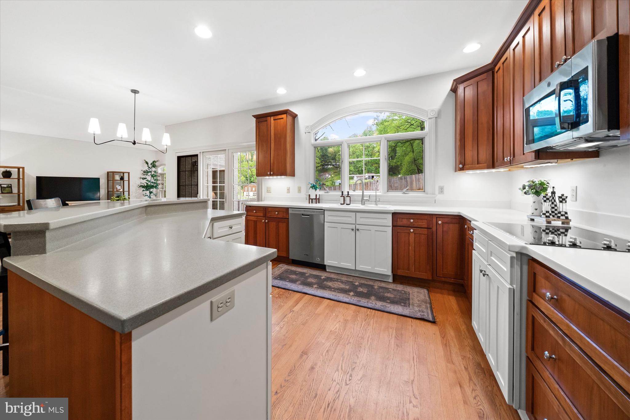 1618 Snuff Mill Road Hockessin, DE 19707 - Photo 17 of 48 a kitchen with stainless steel appliances granite countertop a sink a stove and a refrigerator