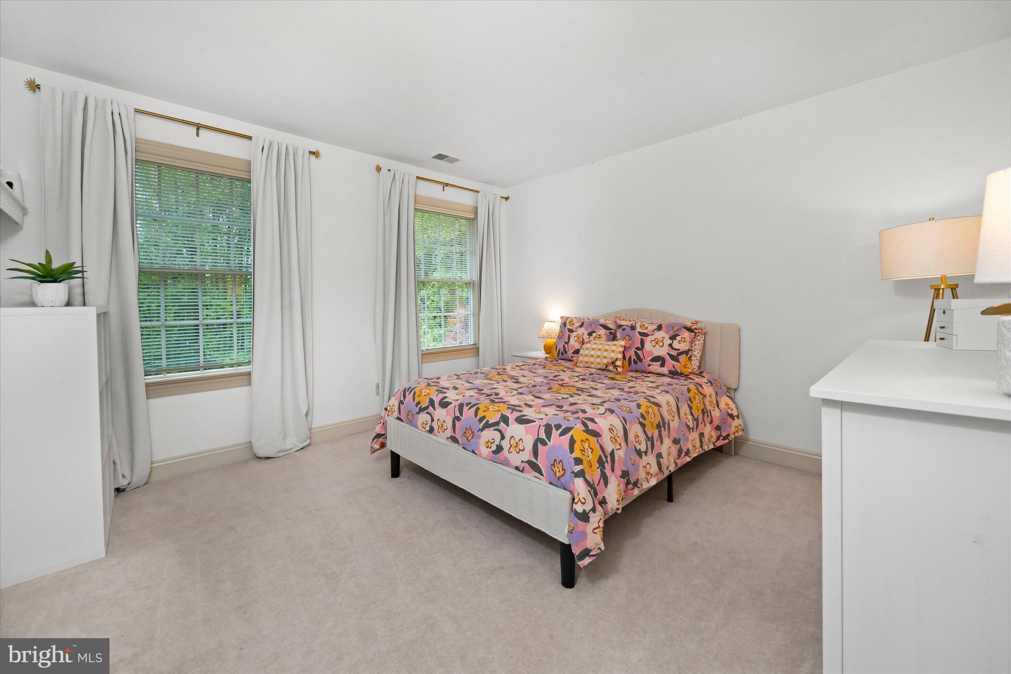 1618 Snuff Mill Road Hockessin, DE 19707 - Photo 31 of 48 a bedroom with a bed lamp and a window