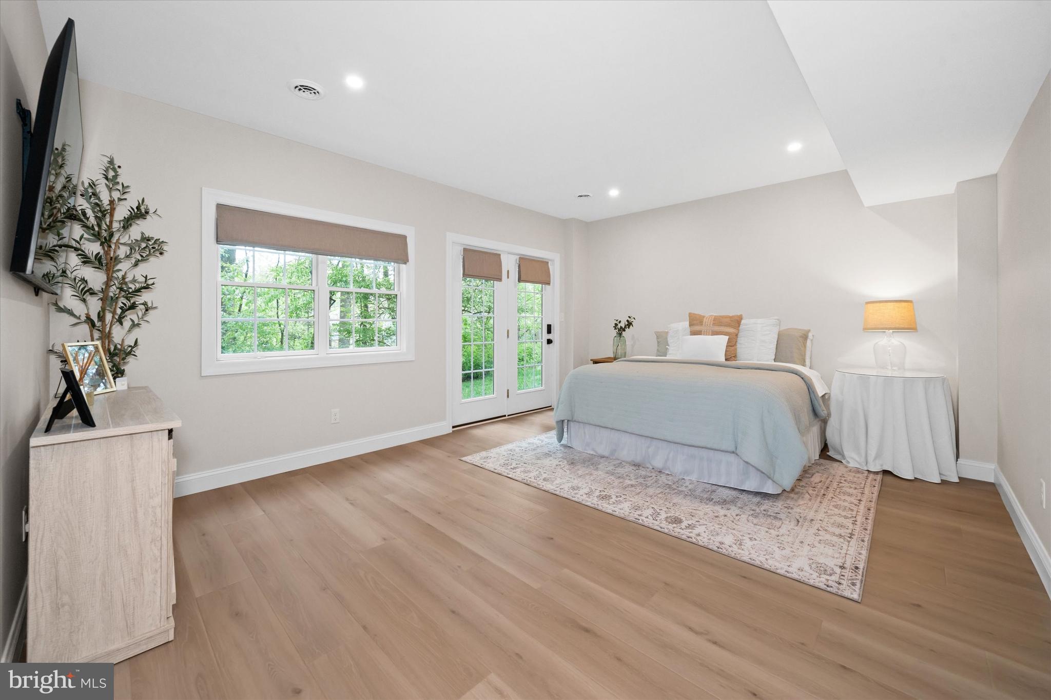 1618 Snuff Mill Road Hockessin, DE 19707 - Photo 36 of 48 a spacious bedroom with a large bed and a wooden floor