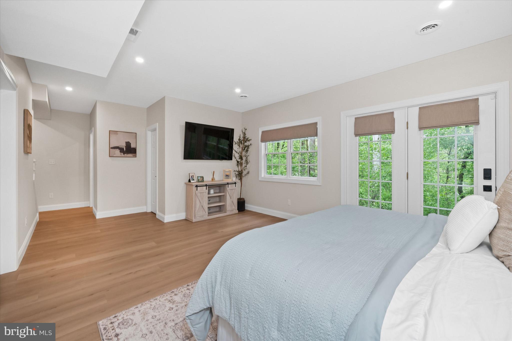 1618 Snuff Mill Road Hockessin, DE 19707 - Photo 37 of 48 a spacious bedroom with a bed and a flat screen tv