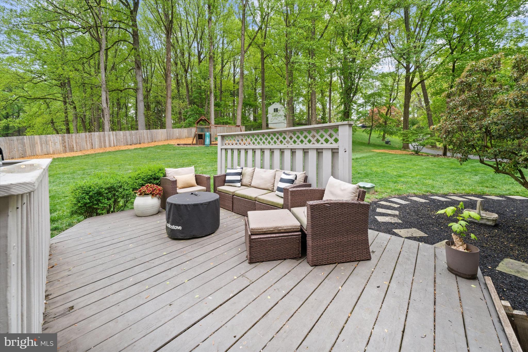 1618 Snuff Mill Road Hockessin, DE 19707 - Photo 41 of 48 a view of a wooden deck with furniture and garden