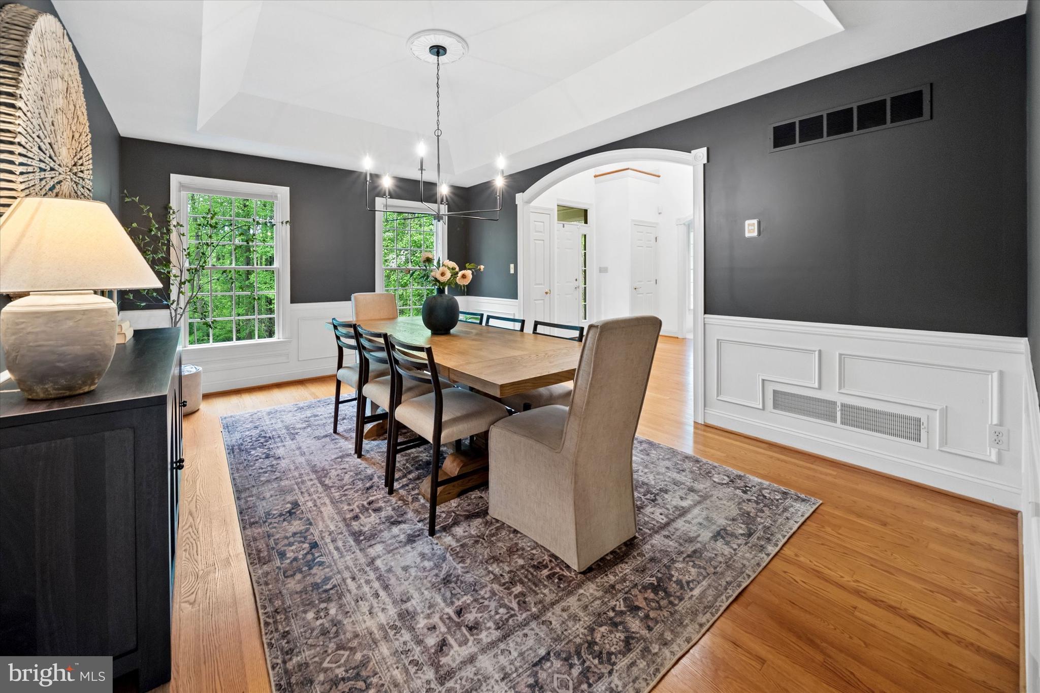 1618 Snuff Mill Road Hockessin, DE 19707 - Photo 7 of 48 a dining room with furniture a chandelier and wooden floor