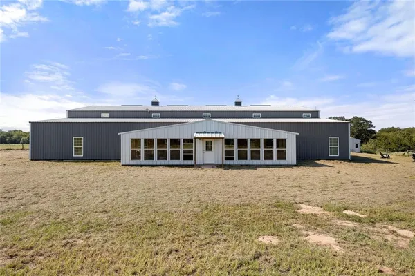 a front view of house with yard and car parked