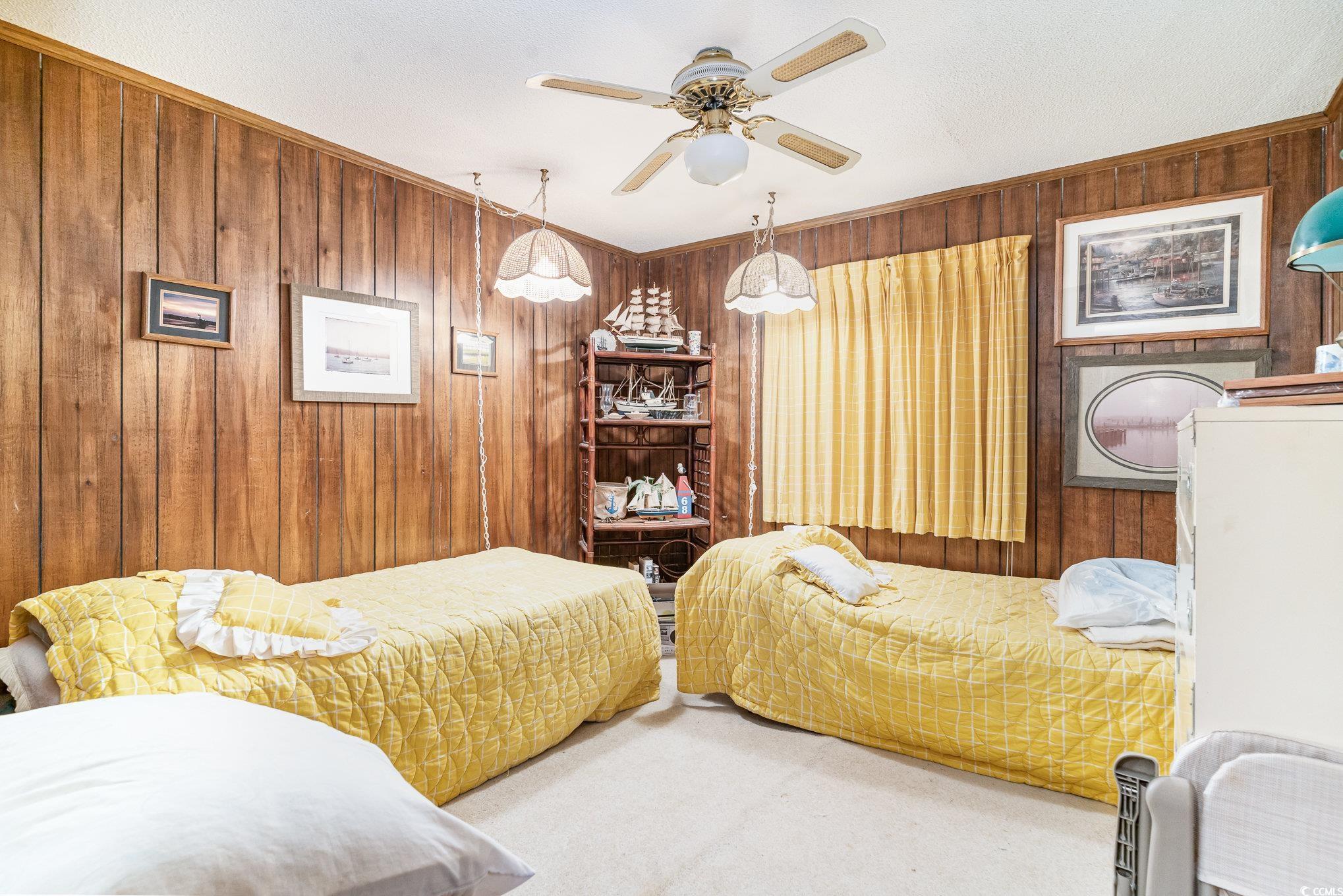 1582 South Waccamaw Drive, Unit 60 Murrells Inlet, SC 29576 - Photo 8 of 24 Bedroom featuring wooden walls and carpet