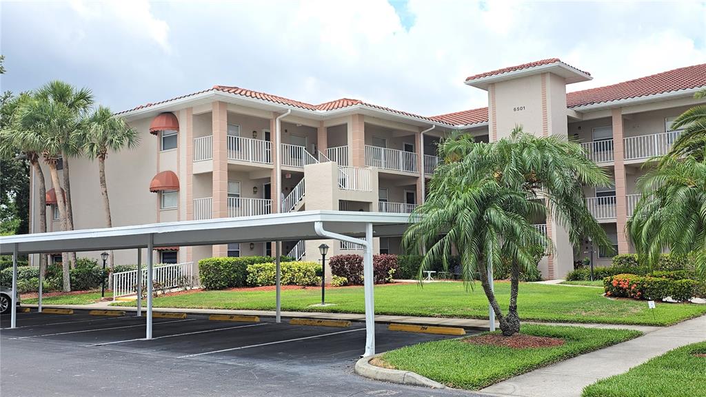 a front view of a building with a garden and plants