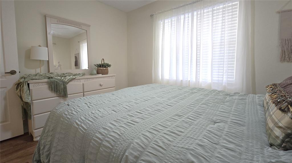 6501 Stone River Road, Unit 201 Bradenton, FL 34203 - Photo 13 of 18 a spacious bedroom with a bed and a large mirror