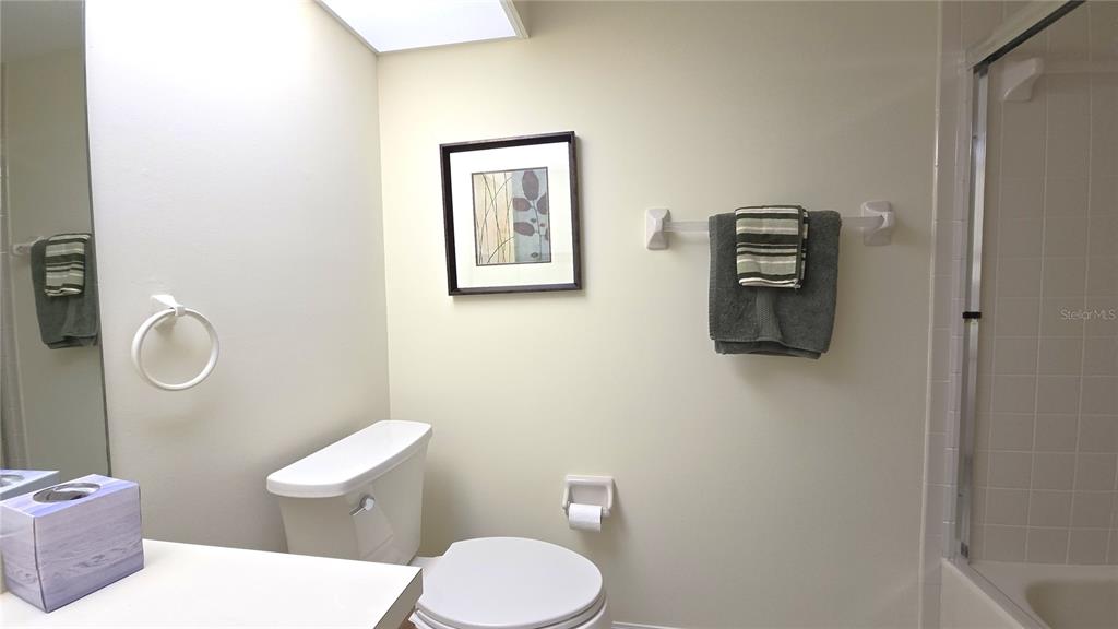 6501 Stone River Road, Unit 201 Bradenton, FL 34203 - Photo 14 of 18 a white toilet sitting next to a bathroom sink