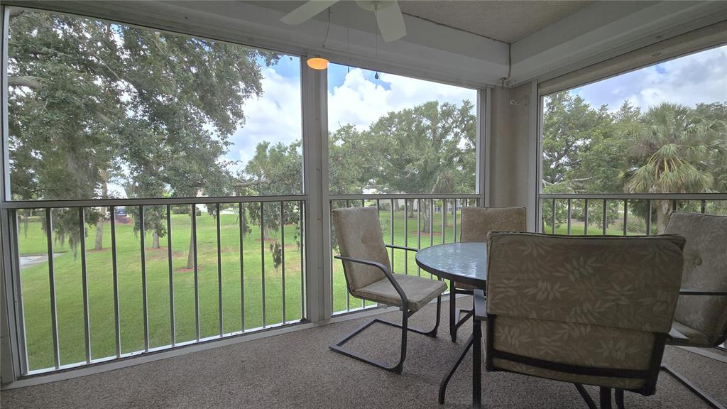 6501 Stone River Road, Unit 201 Bradenton, FL 34203 - Photo 16 of 18 a balcony view with a lake view and a floor to ceiling window
