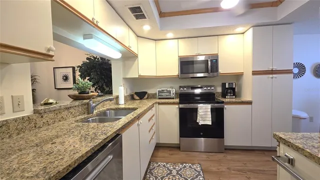 a kitchen with a stove a sink and a microwave