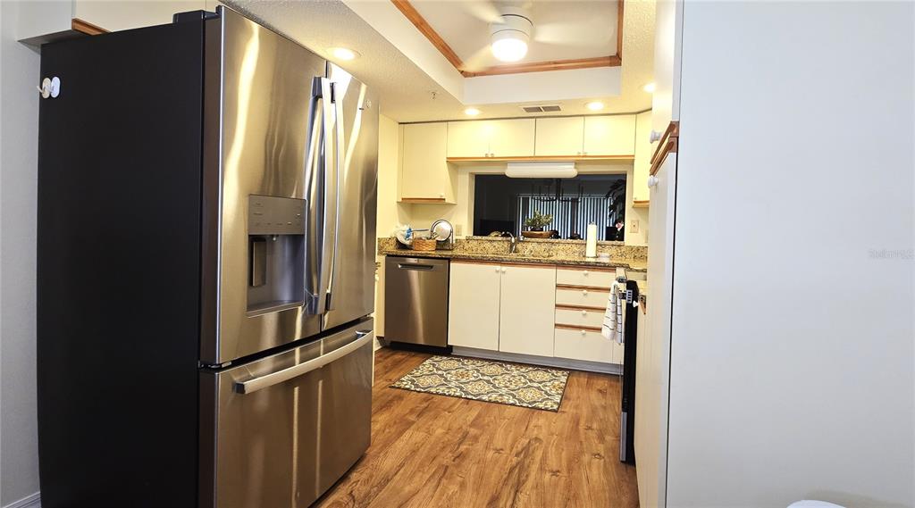 6501 Stone River Road, Unit 201 Bradenton, FL 34203 - Photo 4 of 18 a kitchen with a stove and a refrigerator
