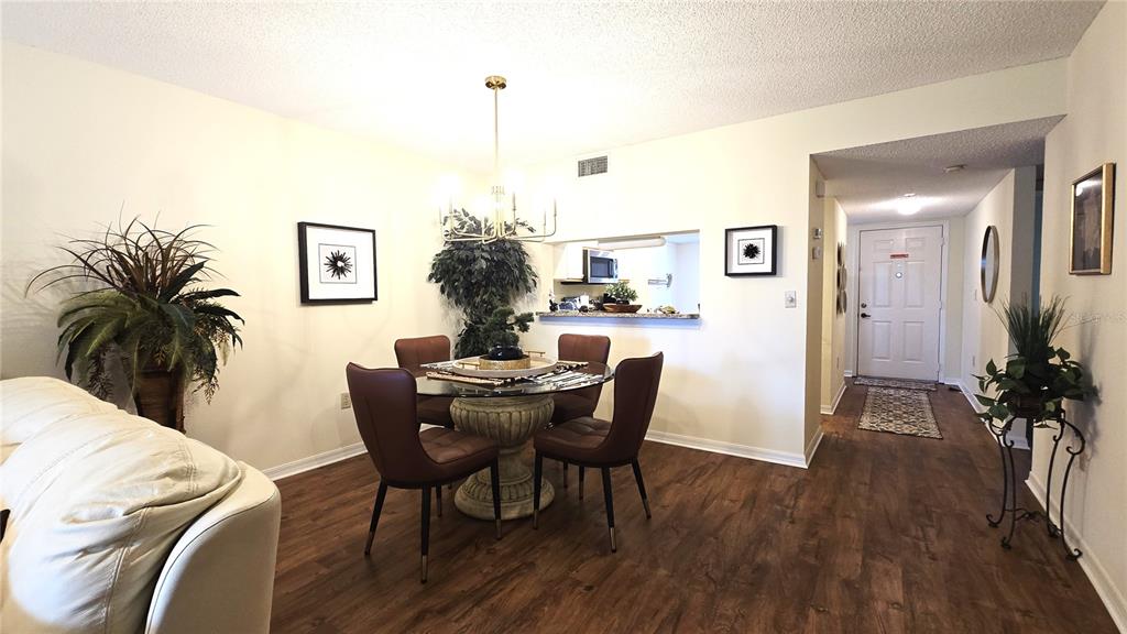 6501 Stone River Road, Unit 201 Bradenton, FL 34203 - Photo 5 of 18 a view of a dining room with furniture and wooden floor