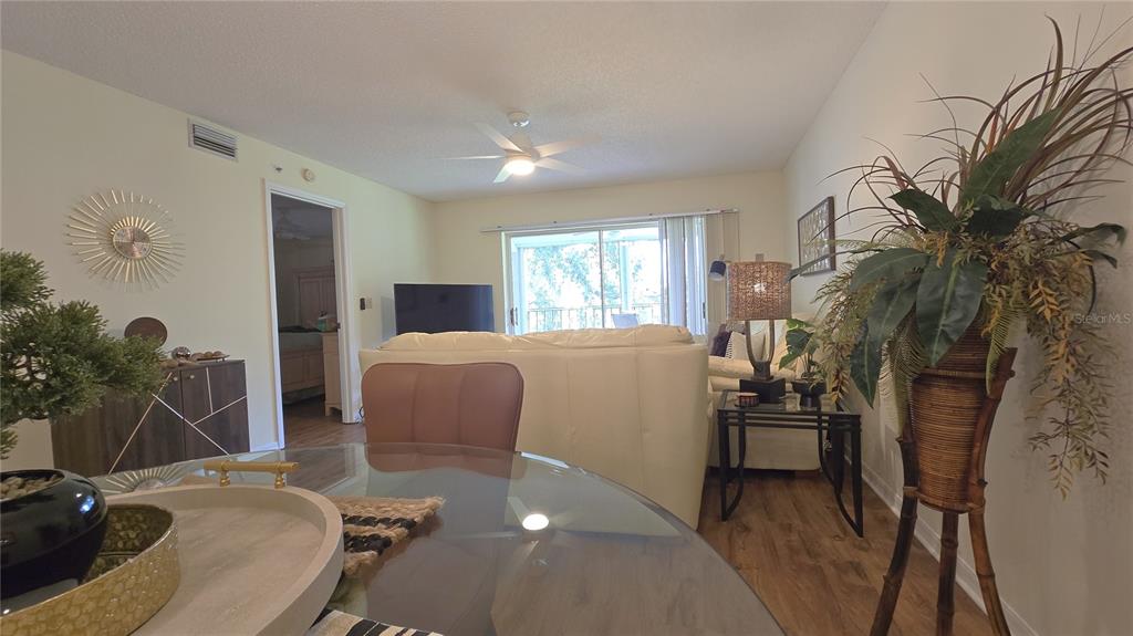 6501 Stone River Road, Unit 201 Bradenton, FL 34203 - Photo 6 of 18 a view of a livingroom with furniture and a floor to ceiling window