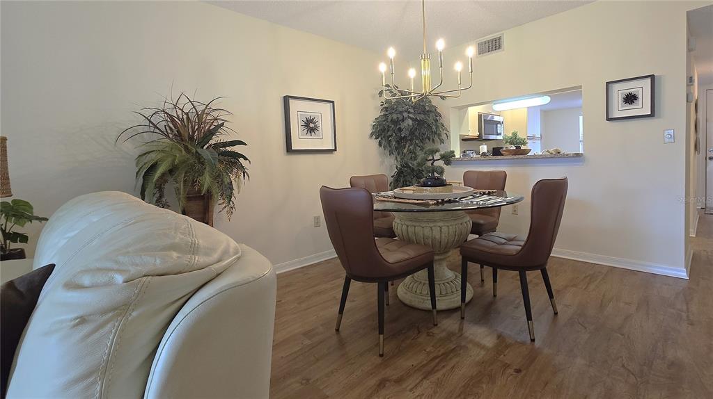 6501 Stone River Road, Unit 201 Bradenton, FL 34203 - Photo 7 of 18 a dining room with furniture and window