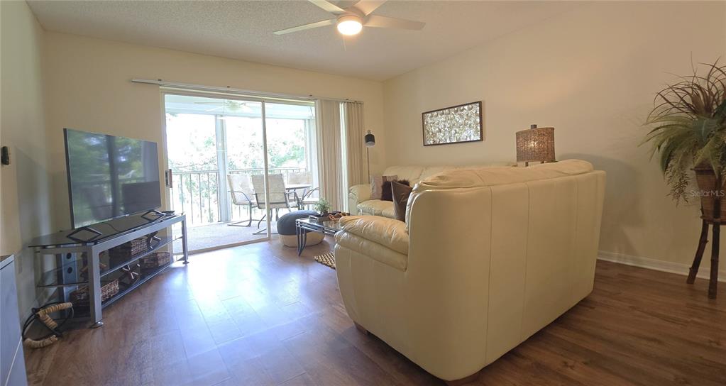 6501 Stone River Road, Unit 201 Bradenton, FL 34203 - Photo 8 of 18 a living room with furniture and a flat screen tv