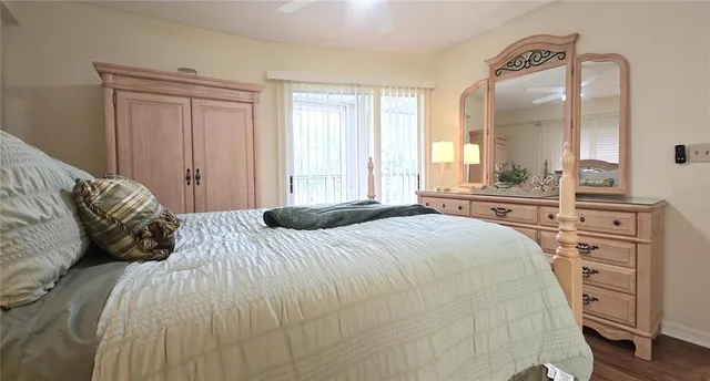 a bedroom with a bed and a large mirror