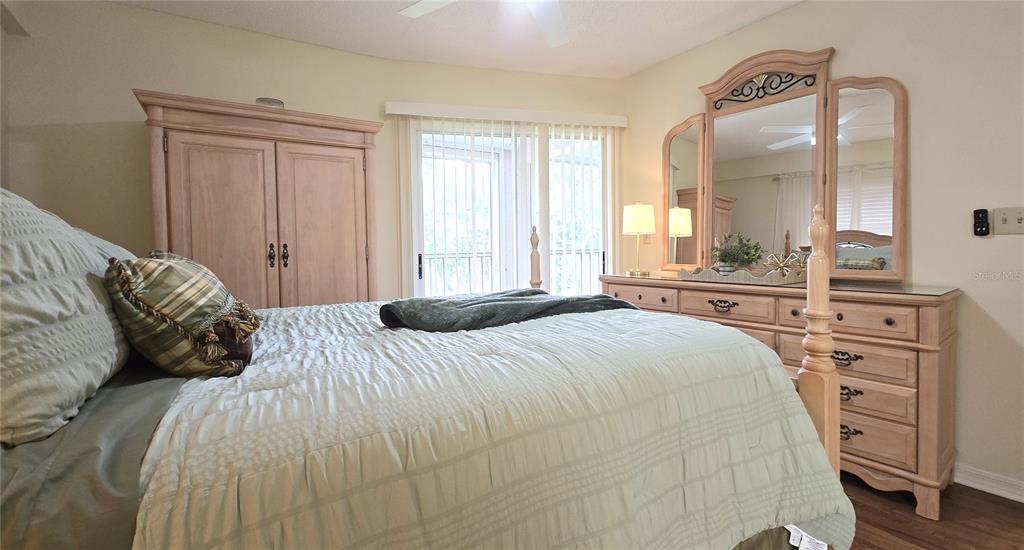 6501 Stone River Road, Unit 201 Bradenton, FL 34203 - Photo 10 of 18 a bedroom with a bed and a large mirror