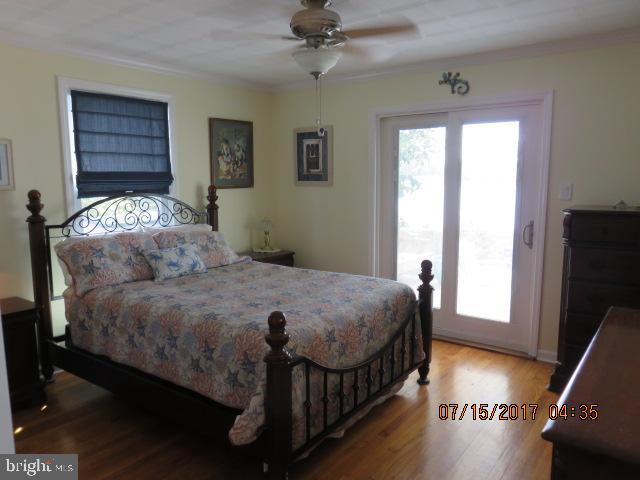 124 Granada Road Pasadena, MD 21122 - Photo 15 of 41 MAIN FLOOR BEDROOM W/HARDWOOD FLOORS