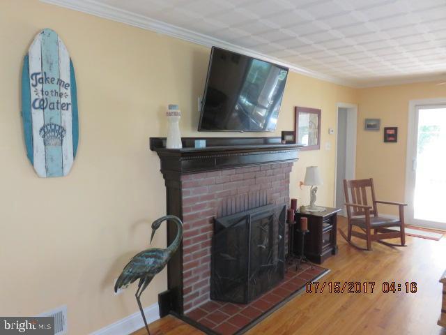 124 Granada Road Pasadena, MD 21122 - Photo 17 of 41 LIVING ROOM BRICK WOOD BURNING FIREPLACE