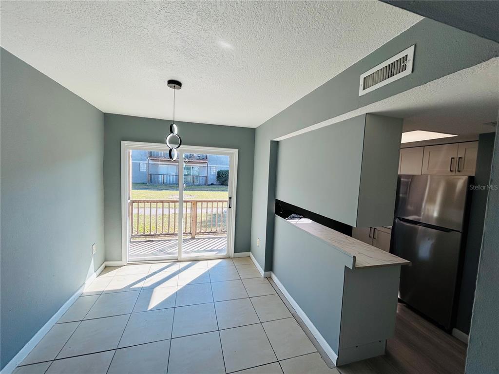 2785 L B McLeod Road, Unit B Orlando, FL 32805 - Photo 2 of 11 a kitchen with a refrigerator a sink and dishwasher