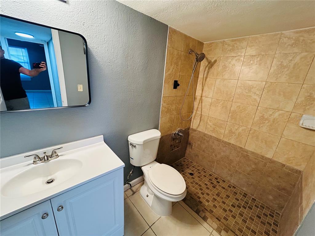 2785 L B McLeod Road, Unit B Orlando, FL 32805 - Photo 7 of 11 a white toilet sitting next to a bathroom sink
