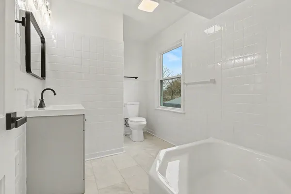 a bathroom with a toilet sink and mirror