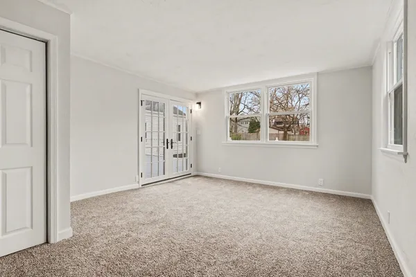 an empty room with windows and closet