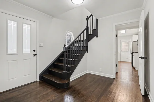 a view of entryway with wooden floor and stairs