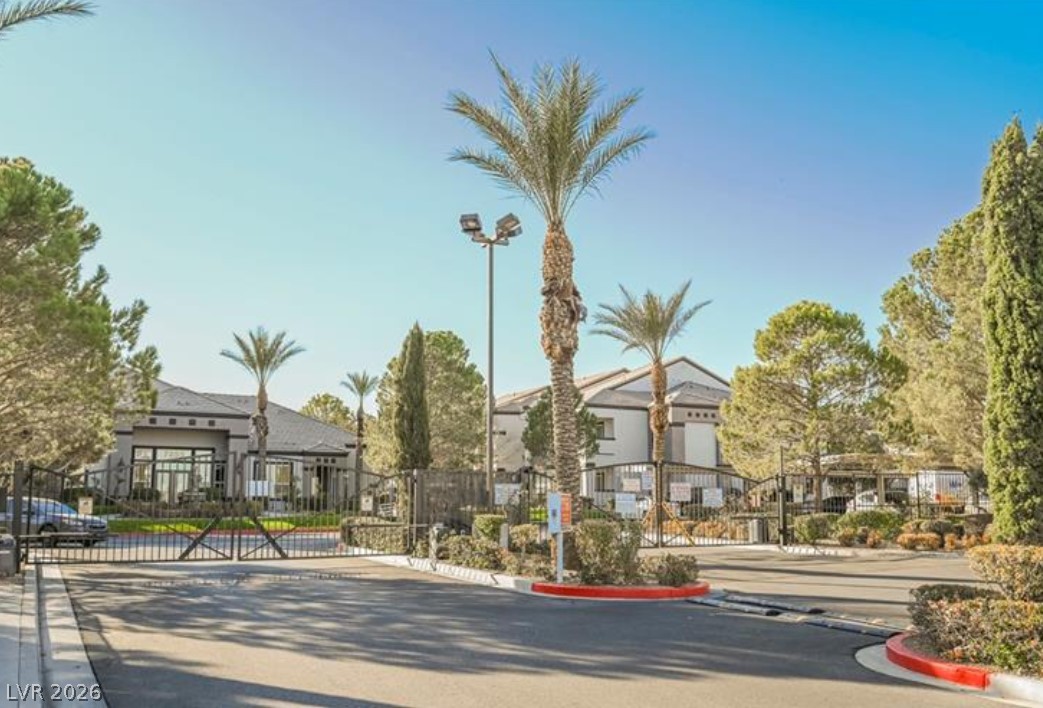 7255 West Sunset Road, Unit 2111 Las Vegas, NV 89113 - Photo 25 of 33 Secure community entrance with palm trees welcomes residents to this desert oasis.