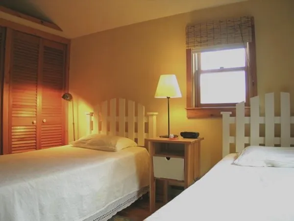 a bedroom with a bed and a lamp