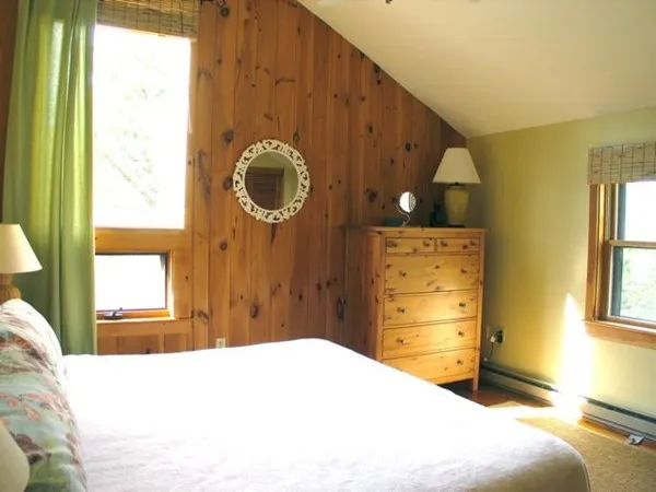 a bedroom with a bed and a window