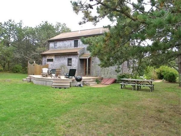a view of a chairs and tables in the back yard of the house