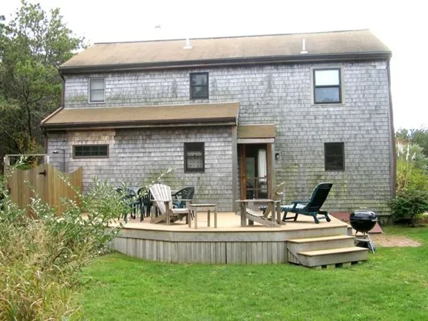 a front view of a house with a garden and patio