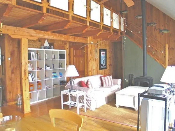 a bedroom with furniture and a large window