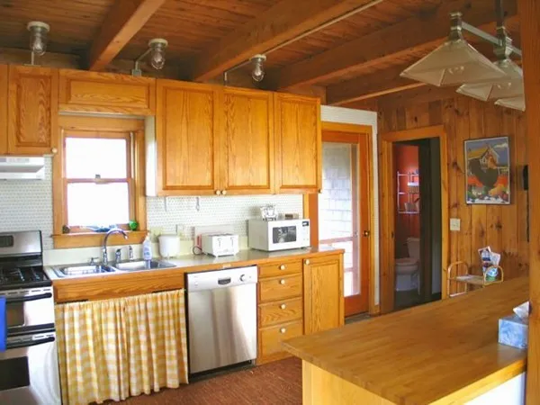 a kitchen with stainless steel appliances granite countertop a sink a stove and a refrigerator