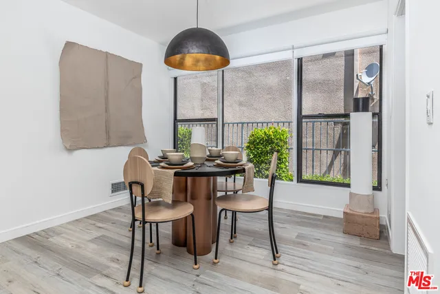 a view of a dining room with furniture window and wooden floor