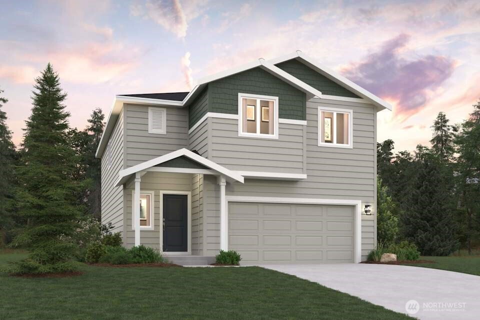 a front view of a house with a garden and yard