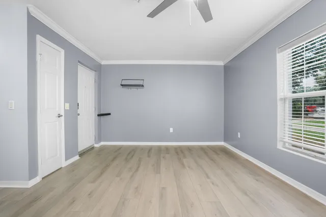 wooden floor in an empty room with a window