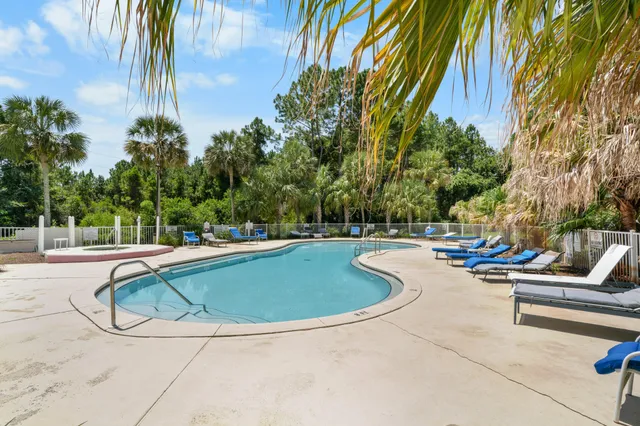 a front view of a house with a garden and trees