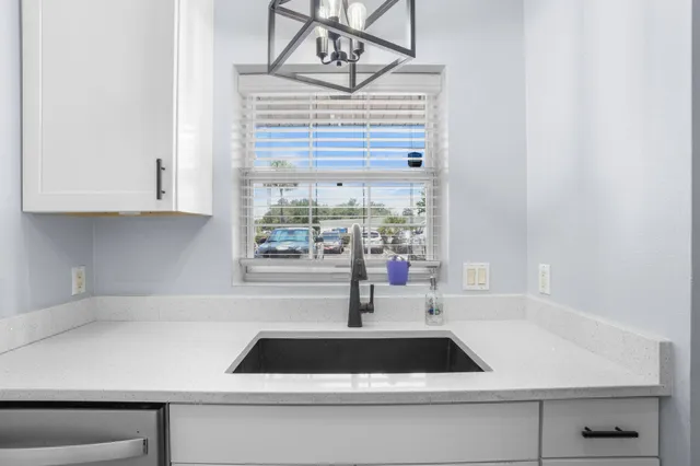 a kitchen with a sink and a window