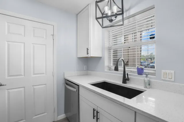a kitchen with a sink and cabinets