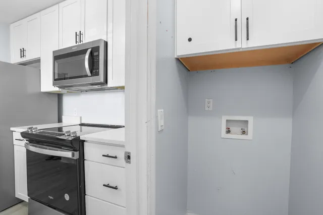 a kitchen with a stove and microwave