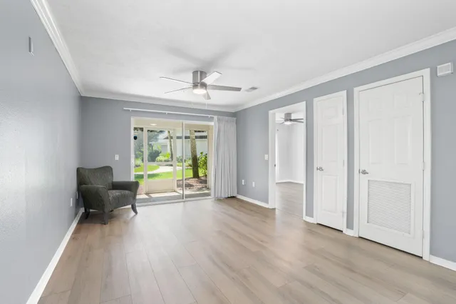 a view of a livingroom with furniture a hardwood floor and a window