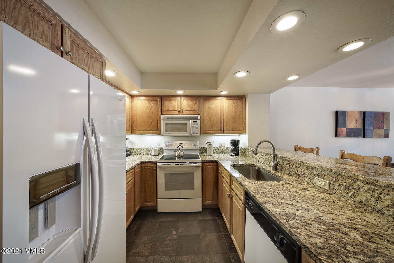 707 West Lionshead Circle, Unit 118 Vail, CO 81657 - Photo 14 of 29 a kitchen with stainless steel appliances granite countertop a sink stove and refrigerator