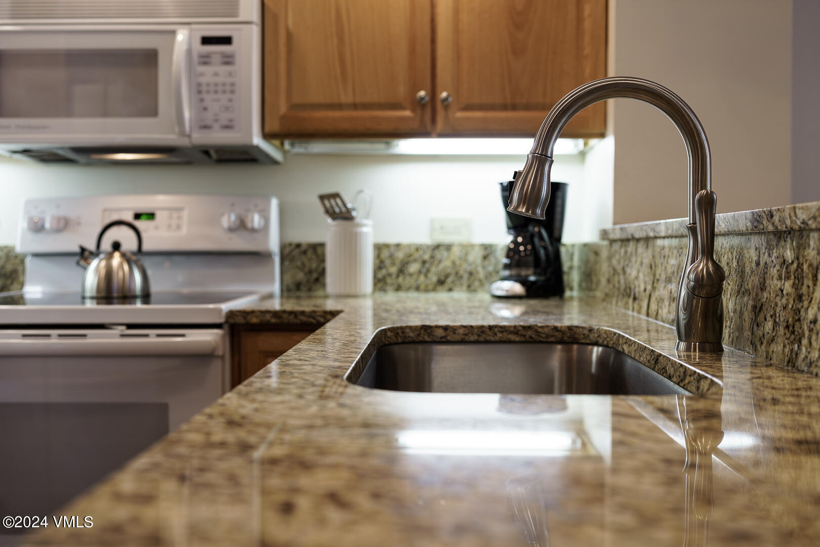707 West Lionshead Circle, Unit 118 Vail, CO 81657 - Photo 16 of 29 a kitchen with a sink and cabinets