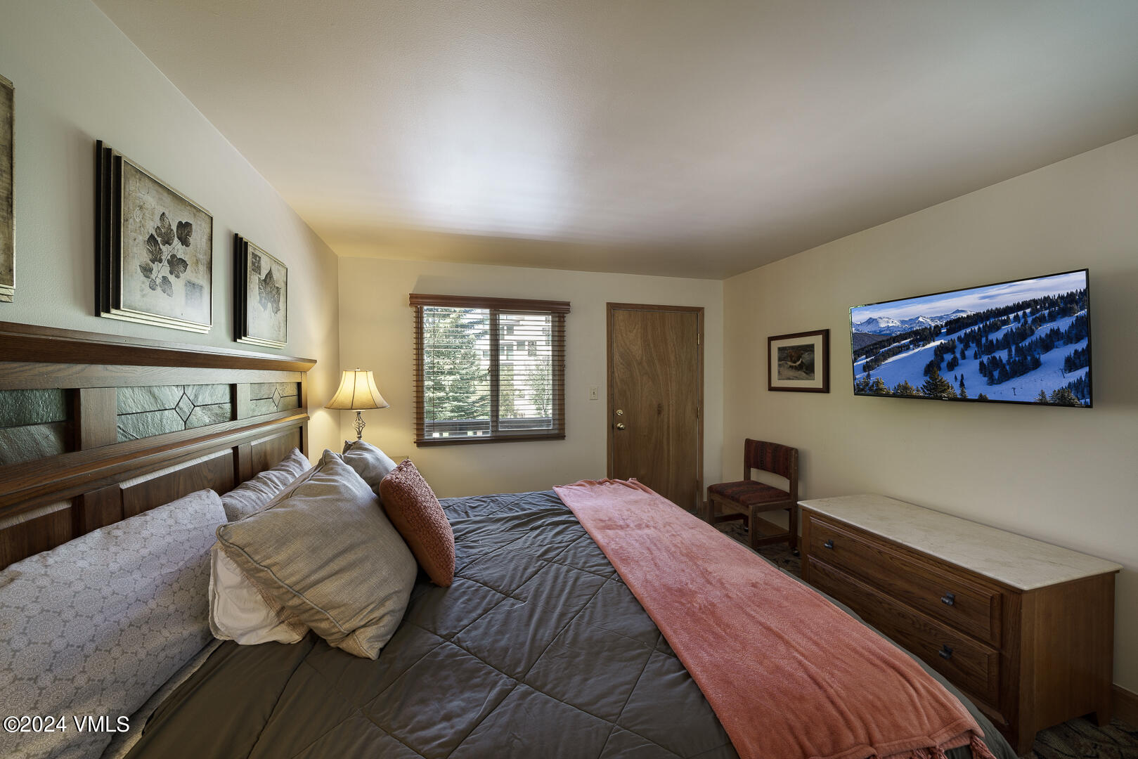 707 West Lionshead Circle, Unit 118 Vail, CO 81657 - Photo 22 of 29 a spacious bedroom with a bed a dresser next to a window