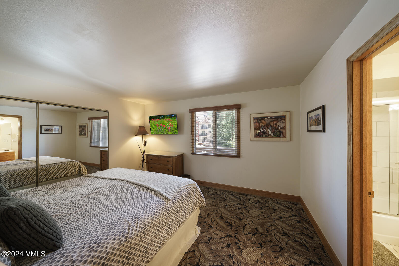 707 West Lionshead Circle, Unit 118 Vail, CO 81657 - Photo 26 of 29 a bedroom with a large bed and a window