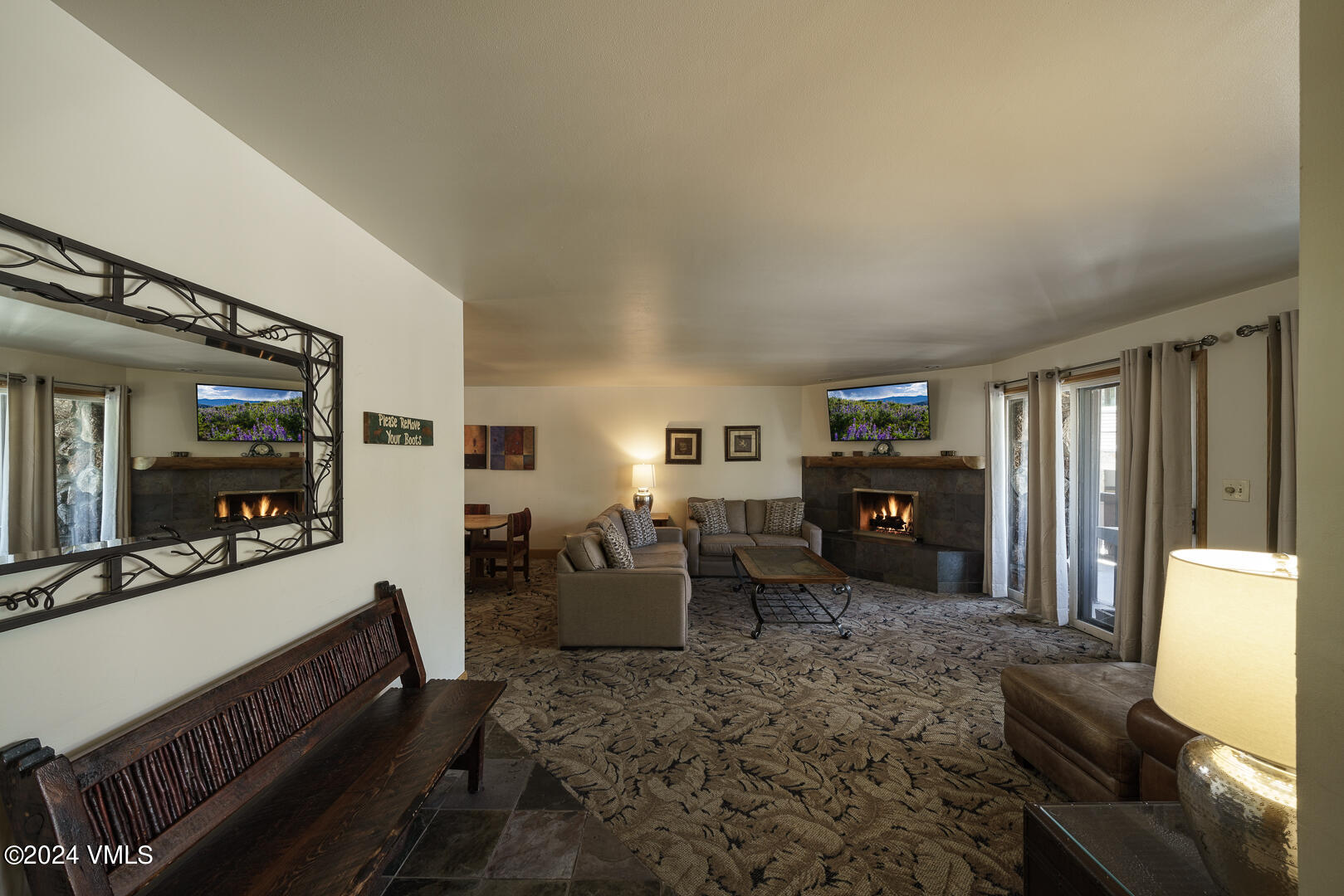 707 West Lionshead Circle, Unit 118 Vail, CO 81657 - Photo 8 of 29 a living room with furniture mirror and a flat screen tv