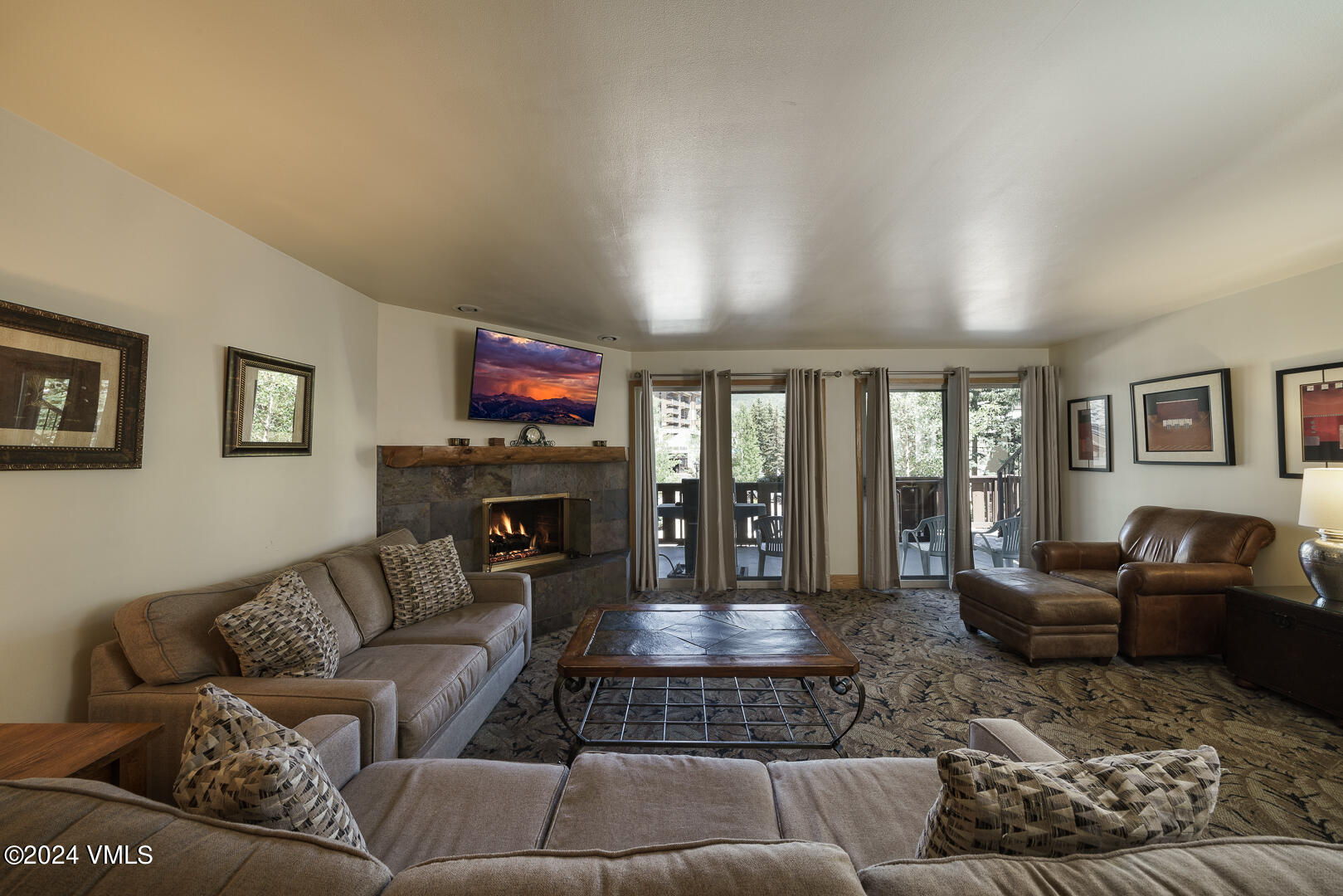 707 West Lionshead Circle, Unit 118 Vail, CO 81657 - Photo 10 of 29 a living room with furniture and a flat screen tv